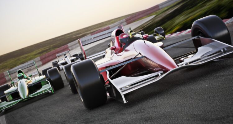 Red race car close up front view on a track leading the pack with motion Blur